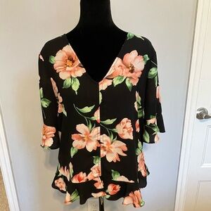 Nice floral blouse with ruffles around the trim. Bright bold flower print.